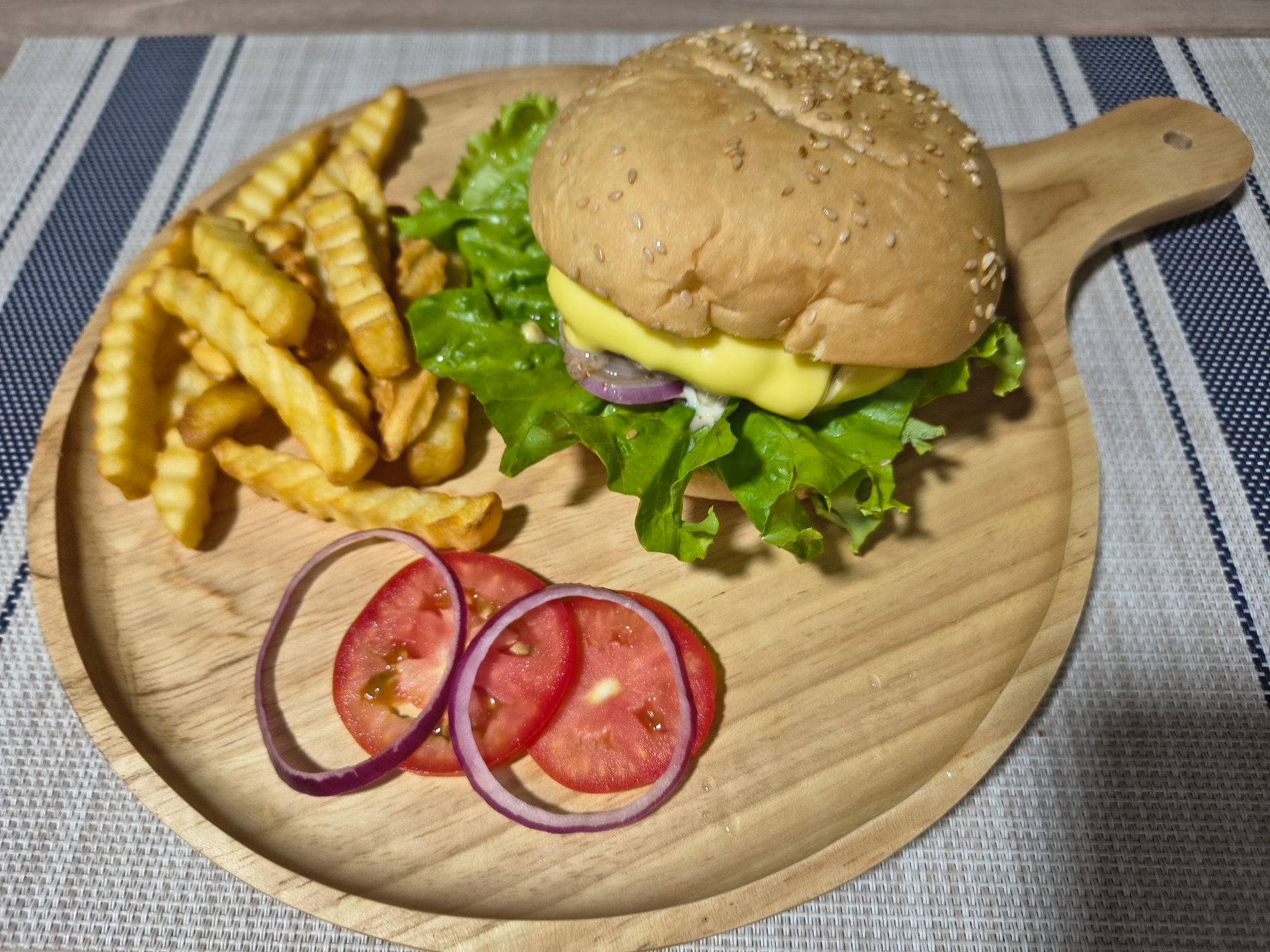 Kwang Kitchen burger with cheese, lettuce, tomato, onion and crinkle-cut fries